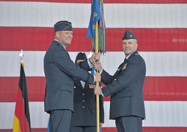Brig. Gen. Jon T. Thomas, 86th Airlift Wing commander, passes the guidon of the 86th Operations Group to Col. Gerald A. Donohue as he takes command of the group during the 86th OG change of command Aug. 5 on Ramstein. As commander of the 86th OG, Donohue will continue to support the 86th Airlift Wing’s mission by providing full spectrum airlift operations.