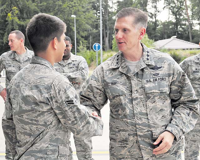 Photo by Airman 1st Class Larissa Greatwood Lt. Gen. Timothy M. Ray, 3rd Air Force commander, coins Airman 1st Class Justin Hernandez, 86th Aircraft Maintenance Squadron aerospace maintenance craftsman, during his 86th Airlift Wing immersion tour Aug. 4 on Ramstein. Ray coined six Airmen in recognition of their individual dedication to go above and beyond within their units.