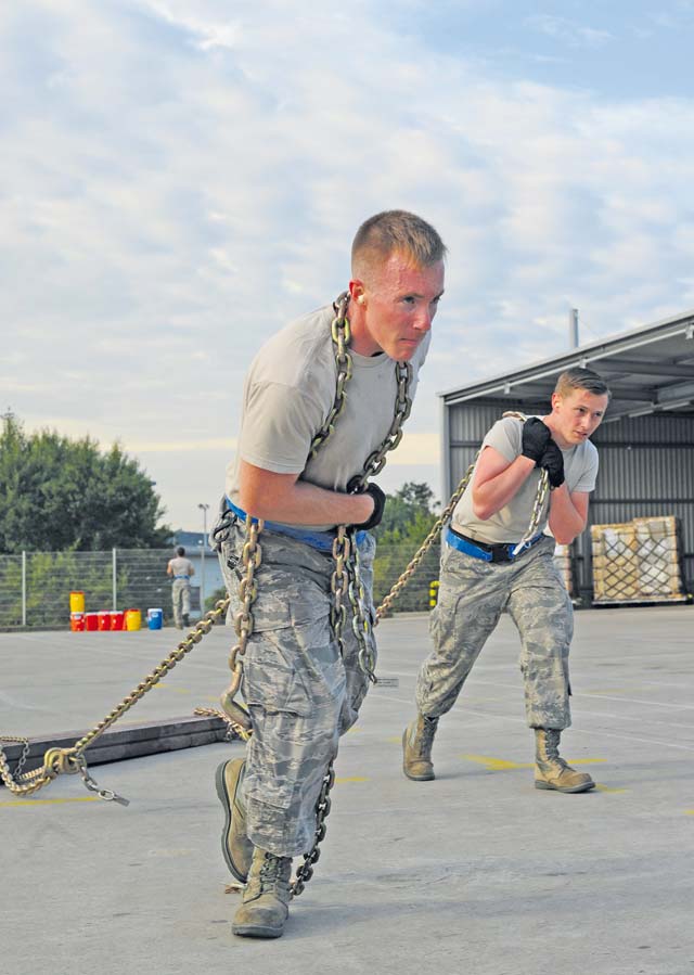 Senior Airman Daniel Hall (left) and Senior Airman Travis Barrett, 721st Aerial Port Squadron passenger service specialists, participate in the obstacle course portion of the rodeo. The 721st APS passenger services team placed first in the knowledge test portion of the event.