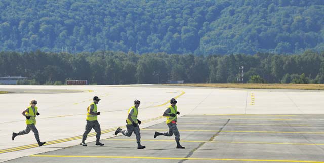 Airmen run on the flightline during the rodeo. The event is a competition aimed at showcasing the skills of the air transportation career field.