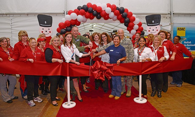 Brig. Gen. Jon T. Thomas, 86th Airlift Wing commander, cuts a ribbon with Lt. Col. Thomas Ausherman, 86th Force Support Squadron commander, and members of the Ramstein Bazaar committee and Ramstein Officers’ Spouses Club Sept. 16 on Ramstein. The ribbon-cutting ceremony officially opened the 51st Ramstein Bazaar.