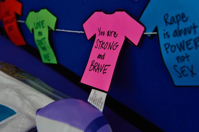 Paper T-shirts hang on a display board during the Ready and Resilient information fair at the Kaiserslautern Military Community Center Sept. 11 on Ramstein. The clothesline project is for people to decorate shirts and hang them to support domestic violence victims. From Oct. 4 through 9, the Family Advocacy Program will be hanging them in the KMCC food court.