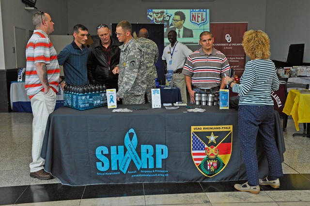 U.S. Army Sgt. 1st Class Lance Clark, 19th Battlefield Coordination Detachment plans NCO in charge and victim advocate, speaks to individuals during the Ready and Resilient information fair at the Kaiserslautern Military Community Center Sept. 11 on Ramstein. Clark was providing attendees with information on the Army Sexual Harassment Assault Response and Prevention program.