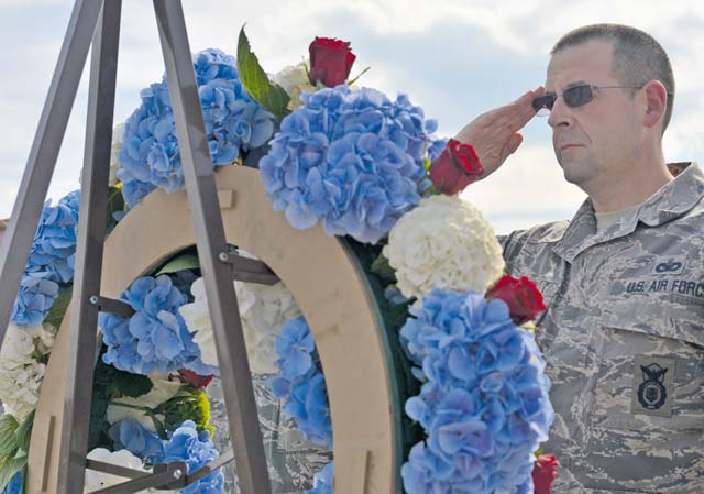 Chief Master Sgt. Edward Keenan, 569th U.S. Forces Police Squadron security forces manager, salutes a wreath on a display during the 9/11 retreat ceremony Sept. 11 on Ramstein. The wreath served as a tribute to the nearly 3,000 lives lost 14 years ago when terrorists hijacked four American airplanes, causing one of the largest domestic terrorist attacks in U.S. history.