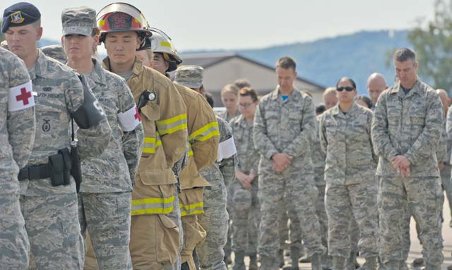 (Left) Airmen take a moment of silence during the 9/11 retreat ceremony Sept. 11 on Ramstein. The retreat paid tribute to the nearly 3,000 lives lost on Sept. 11, 2001, in one of the deadliest terrorist attacks on American soil.