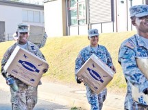 (Left to right) Staff Sgt. Jessica Gregor, Sgt. 1st Class Marcus Mitchell, Sgt. Maj. Michael Ledesma and Master Sgt. Addley Saimbert, all members of the Rheinland-Pfalz chapter of the Sergeant Morales Club and NCOs assigned to the 21st Theater Sustainment Command, move boxes and furniture at Sembach Middle and Elementary Schools Aug. 26. The first official day of school for the Department of Defense Education Activity students was Aug. 31.