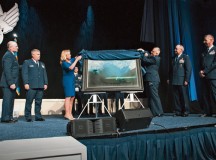 Air Force Secretary Deborah Lee James and Maj. Warren Neary, the Air Force Space Command historian and an Air Force Art Program artist, unveil the painting “That Others May Live” during the Air Force Association Air and Space Conference and Technology Exposition Sept. 14 in Washington, D.C.