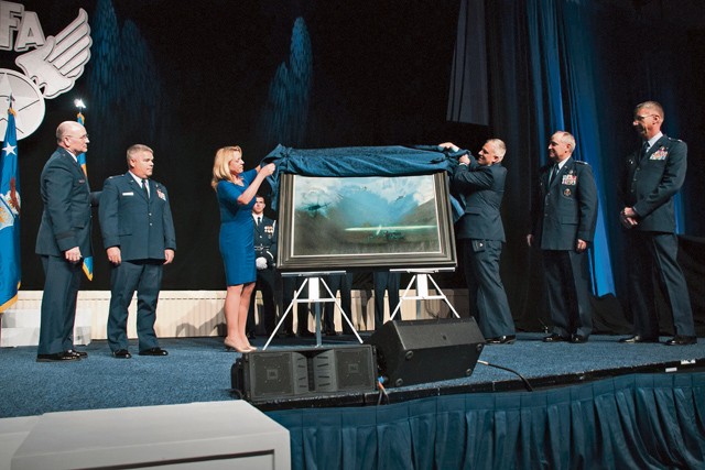 Air Force Secretary Deborah Lee James and Maj. Warren Neary, the Air Force Space Command historian and an Air Force Art Program artist, unveil the painting “That Others May Live” during the Air Force Association Air and Space Conference and Technology Exposition Sept. 14 in Washington, D.C. 