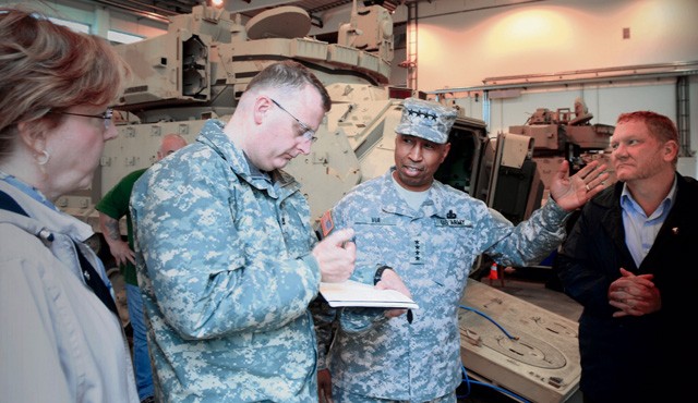 Gen. Dennis L. Via, commanding general of U.S. Army Materiel Command, discusses details of the European Activity Set with 405th Army Field Support Brigade Commander Col. Todd Bertulis while Lisha Adams, AMC executive deputy to the commanding general (far left), and Robin Dothager, 405th AFSB prepositioned stocks manager (far right), listen in.