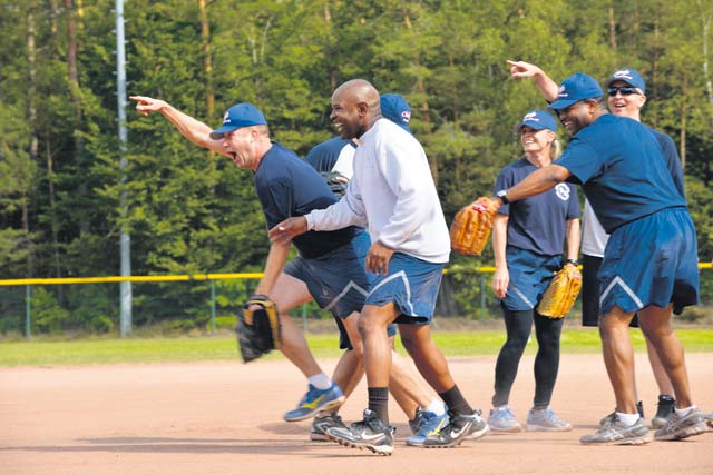 Leaders from Team Ramstein share a laugh during the Chiefs (chief master sergeants) and Eagles (colonels) softball game Sept. 9 on Ramstein. The softball game was part of the 86th Airlift Wing's Commander's Challenge. The Eagles defeated the Chiefs 24-20.