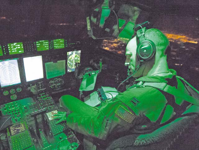 Photo by Senior Airman Jonathan Stefanko A pilot from the 41st Airlift Squadron at Little Rock Air Force Base, Ark., inputs communication frequencies inside an 86th Airlift Wing C-130J Super Hercules Aug. 25 above Romania. Swift Response is a joint and combined certification training event integrating multinational Brigade Task Forces from 11 NATO nations to include the U.S., Germany, Italy, the United Kingdom and Greece. U.S. Airmen were drawn from active duty, Air Force Reserve and Air National Guard to participate in the exercise to refine and hone their skills.