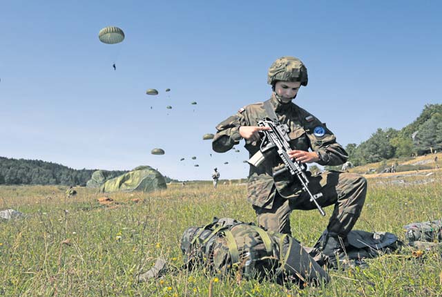 Photo by Spc. William Lockwood A Polish paratrooper with the 6th Polish Airborne Brigade unpacks his backpack after parachuting out of a plane Aug. 26 during Swift Response 15 in Hohenfels, Germany. Swift Response is a combined airborne training event with participation of more than 4,800 service members from 11 NATO nations.