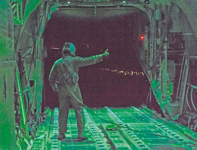 Photo by Senior Airmen Jonathan Stefanko A loadmaster assigned to the 41st Airlift Squadron, Little Rock Air Force Base, Ark., gives the all-clear after cargo is released from a C-130J Super Hercules Aug. 25 above Romania as part of exercise Swift Response.
