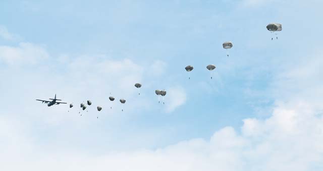 Photo by Spc. Nikayla Shodeen Polish army paratroopers descend on Bunker Drop Zone after exiting a C-130J Hercules at the 7th Army Joint Multinational Training Command's Grafenwoehr Training Area, Germany, Aug. 24. The jump was conducted as a practice jump before the joint force entry drop on Aug. 26 in support of exercise Swift Response 15.