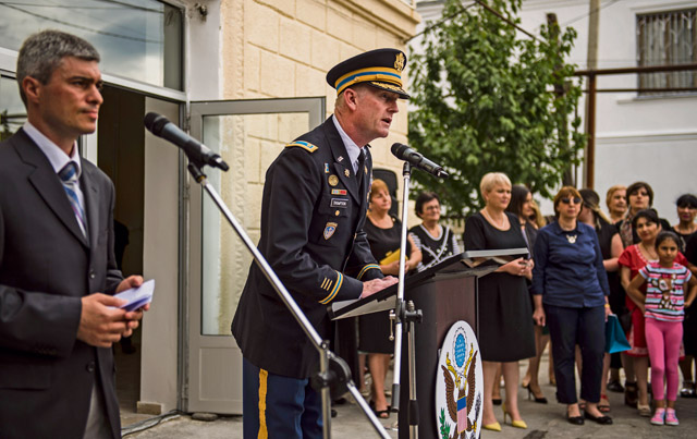 U.S. Army Maj. Colin Thompson, Office of Defense Cooperation Bilateral Affairs Officer, speaks to a group of teachers and community members during the opening ceremony of Public School No. 4 Aug. 31 in Gori, Georgia. The ceremony was held as a celebration for the completion of the Georgian Humanitarian and Civic Assistance project led by U.S. European Command.