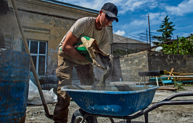 U.S. Air Force Airman 1st Class Cole Kasten, 52nd Civil Engineer Squadron pavement and heavy equipment operator, mixes cement for a ramp at Public School No. 4 Aug. 28 in Gori, Georgia.