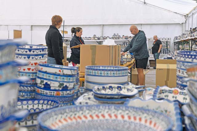 Photo by Senior Airman Holly Mansfield Ramstein Bazaar volunteers set out Polish pottery Sept. 20, 2014, on Ramstein. 