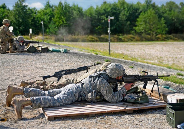 Photo by Staff Sgt. Warren W. Wright Jr. Competitors from the 2nd Cavalry Regiment engage targets with the M249 squad automatic weapon during the 2015 European Best Warrior Competition Sept. 15 at the Grafenwoehr Training Area.