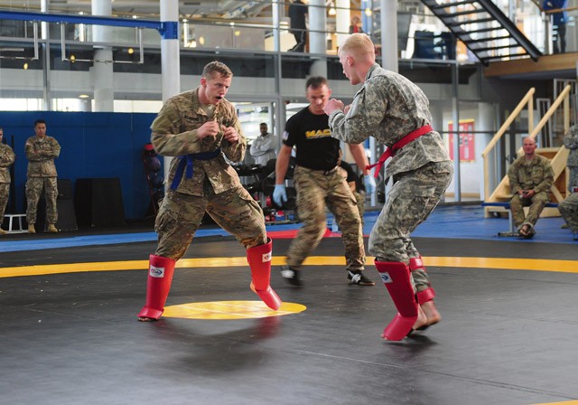 Photo by Staff Sgt. Warren W. Wright Jr. The 173rd Airborne Brigade’s 1st Lt. Jacob Wijnberg (left), Europe’s 2015 Best Officer Warrior, engages a fellow competitor during the “combatives” tournament held Sept. 18 at the Grafenwoehr Physical Fitness Center. 