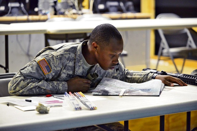 Photo by Visual Information Specialist Gertrud Zach Sgt. Kendrick Jones, assigned to Headquarters and Headquarters Company, 1st Battalion, 4th Infantry Regiment, accomplishes the call for a fire task Sept. 16 during the 2015 European Best Warrior Competition at Grafenwoehr Training Area.