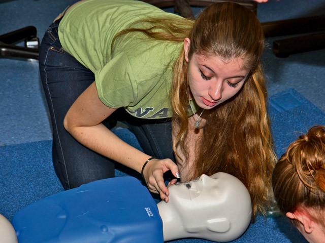 Photos by the 7th Civil Support Command Public Affairs Office Renee Gladu, a candidate in the Certified Nursing Assistant program at Ramstein High School, performs lifesaving procedures on a clinic dummy during training for licensing as a nursing assistant Sept. 13 at RHS.