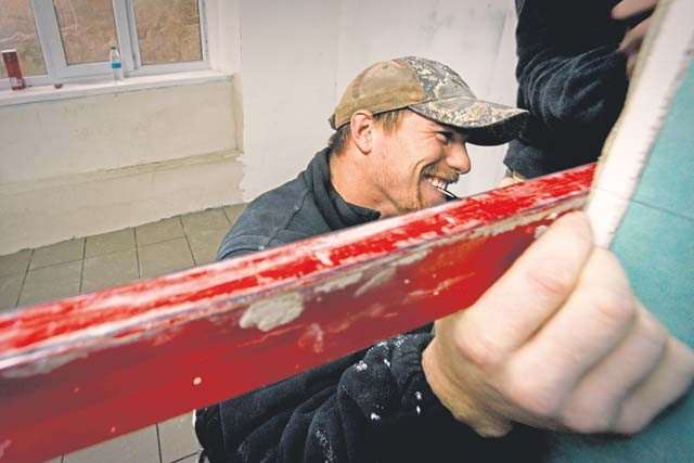 Senior Airman Bradley Cain, 435th Construction and Training Squadron structural craftsman, helps remodel a gym locker room  Oct. 18 at Liceul Teoretic Alexei Mateevici School in Sanatauca, Moldova. 