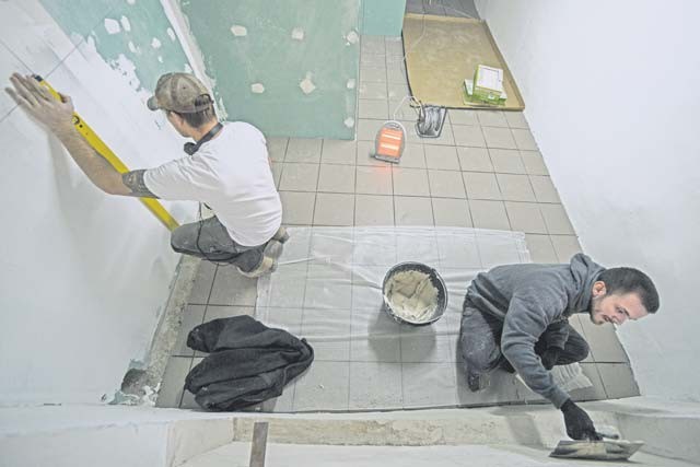 Senior Airman Bradley Cain and Staff Sgt. Dorsey Sirmans, 435th Construction and Training Squadron structural craftsmen, renovate a locker room Oct. 18 at Liceul Teoretic Alexei Mateevici School in Sanatauca, Moldova.