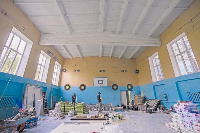 Airmen from the 435th Construction and Training Squadron and 52nd Civil Engineer Squadron mix cement for renovations in a locker room Oct. 18 at Liceul Teoretic Alexei Mateevici School in Sanatauca, Moldova.