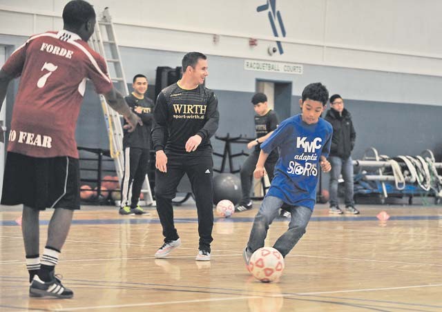 Elijah Muhammad, Ramstein Middle School student, dribbles the ball toward a goal during the KMC Adaptive Sports soccer event Oct. 15 on Vogelweh. Special needs students from Ramstein and Vogelweh middle and high schools had the opportunity to play soccer against each other and build camaraderie. 