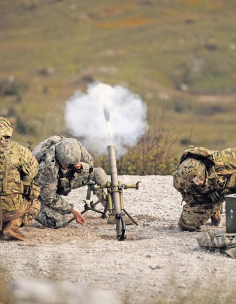 U.S. Soldiers take cover after firing a mortar round Oct. 19 at Pocek Training Range near Postojna, Slovenia. Mortarmen from the 2nd Battalion, 503rd Infantry Regiment supported exercise Rock Proof V with indirect fire as Soldiers and Airmen from the 435th Air Ground Operations Wing joined exercise Rock Proof V, which was designed to build interoperability between U.S. and Slovenian militaries and maintain strong ties between NATO allies.