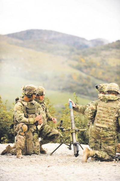 U.S. Army Specialist Nigeal Yago, 2nd Battalion 503rd mortarman (left), directs his mortar crew during a live-fire training scenario Oct. 19 at Pocek Training Range near Postojna, Slovenia.