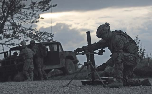 U.S. Army Specialist Nigeal Yago, 2nd Battalion 503rd mortarman, calibrates his mortar during a training scenario Oct. 18 at Pocek Training Range near Postojna, Slovenia.