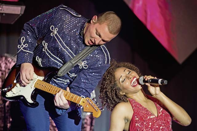 Senior Airman Trenton Hays plays the guitar while 2nd Lt. Nicque Robinson sings during a Tops in Blue performance Sept. 27 on Ramstein. Tops in Blue is produced by the Entertainment Branch of the Programs Directorate, Headquarters Air Force Services Agency, San Antonio.