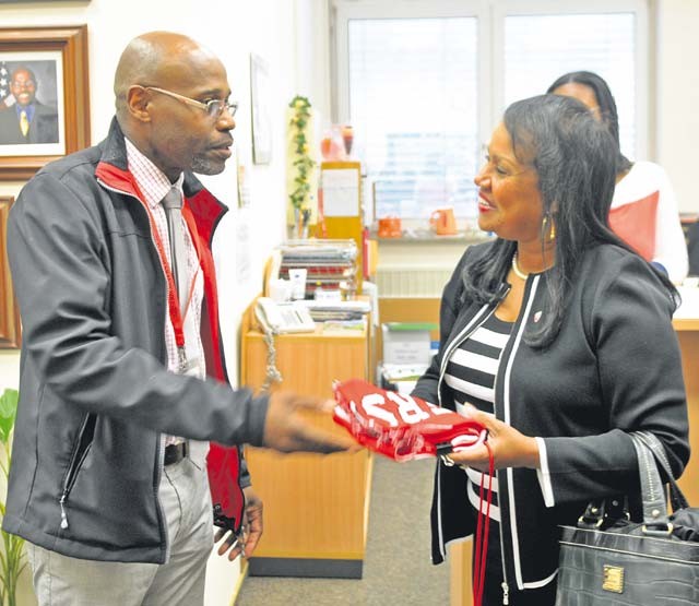 Linda Via, wife of Gen. Dennis L. Via, commanding general of U.S. Army Materiel Command, accepts a team scarf from Dr. Barriet Smith, principal of Kaiserslautern High School, while visiting the school on Vogelweh Sept. 14. KHS was one stop on a whirlwind tour in which Via visited a number of Army agencies and schools in Kaiserslautern and surrounding areas.
