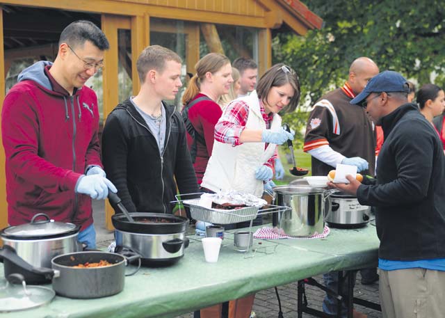 Soldiers and family members from the 21st Theater Sustainment Command’s Special Troops Battalion serve chili at a chili cook-off during a STB Fall Festival Sept. 26 on Daenner Kaserne. Along with the chili cook-off, attendees enjoyed a day full of activities including face painting, games, sports, arts and crafts and hay rides.