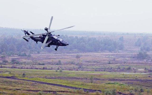 A helicopter flies over the battlefield during the live-fire portion of distinguished visitor day of the German army’s Joint Demonstration Exercise Oct. 9 at the German army training area in Muenster. The German army hosted more than 100 visitors, including key leaders from the Kaiserslautern-based 21st Theater Sustainment Command, demonstrating capabilities of the German land forces. The demonstrations included maneuvers by a combined arms battalion, a presentation at a theater logistics base and a combined arms live-fire exercise.