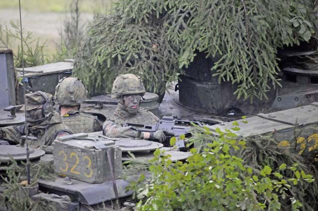 A German soldier keeps watch from the back of an infantry fighting vehicle during the distinguished visitor day of the German army’s Joint Demonstration Exercise Oct. 9 at the German army training area in Muenster.