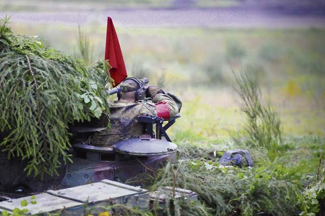 A German soldier scans the battlefield from atop an infantry fighting vehicle during the live-fire portion of distinguished visitor day at the German army’s Joint Demonstration Exercise Oct. 9 at the German army training area in Muenster. 