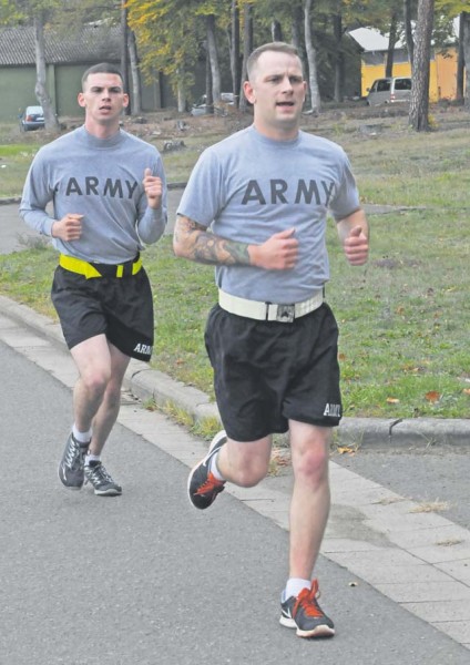 Sgt. Trevor Dodds, 5th Battalion, 7th Air Defense Artillery Regiment, 10th Army Air and Missile Defense Command, races toward the finish line just ahead of Sgt. Phillip Smith, military policeman with the 615th MP Company, 709th MP Battalion, part of the 21st Theater Sustainment Command’s 18th MP Brigade, during the two-mile run performed Oct. 22 at Rhine Ordnance Barracks during an Army Physical Fitness Test conducted as part of the Sergeant Morales Club board.