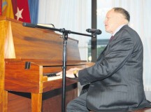 Retired Maj. Gen. Douglas L. Carver, the 22nd Army chief of chaplains, took a turn at the piano before taking to the podium during the Rheinland-Pfalz community prayer breakfast Oct. 21 at the Ramstein Officers’ Club.