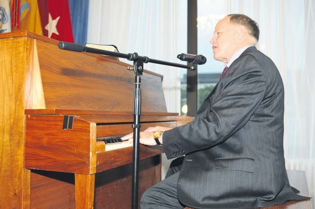 Retired Maj. Gen. Douglas L. Carver, the 22nd Army chief of chaplains, took a turn at the piano before taking to the podium during the Rheinland-Pfalz community prayer breakfast Oct. 21 at the Ramstein Officers’ Club.
