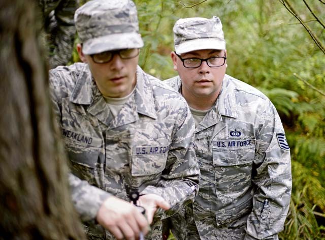 Staff Sgt. Cody Weakland and Tech. Sgt. Joshua Wisnewski, both 7th Weather Squadron battlefield weather Airmen, search for a fixed location in the woods of Grafenwoehr Training Area, Germany, Sept. 16. The Airmen participated in Cadre Focus along with 30 other battlefield weather Airmen to enhance their skills and abilities in order to better support Army units.