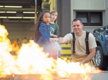 Master Sgt. Mark Goenen, 86th Civil Engineer Squadron KMC Fire Emergency Services, shows children how to properly use a fire extinguisher 
Oct. 8 on Ramstein. As part of Fire Prevention Week, families visited Fire Station 1 to learn about fire safety including home-fire safety issues, fire extinguisher training and holiday safety tips.