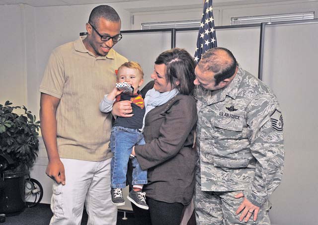 Sean Tatum, 86th Force Support Squadron caregiver, stands with the Dalmo family for photos during a Red Cross Lifesaving Award ceremony Oct. 8 on Ramstein. Tatum utilized his Red Cross health and safety skills to dislodge food from Jackson Dalmo’s throat July 1.