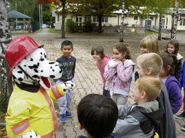 Courtesy photos Firefighters Carsten Beberich, Patrick Stephan and Marcel Kolb visited Landstuhl Elementary and Middle School recently to talk about fire safety. Students in Julie Wittenberg’s class were excited and captivated by Sparky the Fire Dog.