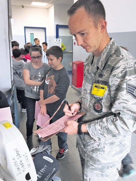 Staff Sgt. David Lund, 86th Civil Engineer Squadron, Civil Engineer Fire Department, mans the blood pressure station while Students at Ramstein Middle School receive their annual health screening. With the assistance of volunteers from numerous organizations within the base medical community, more than 860 students in grades six through eight were seen in three short days. Among the many organizations that provided volunteers were the U.S. Air Forces in Europe Surgeon General, 86th Aerospace Medical Squadron, 86th CES, 86th Aeromedical Evacuation Squadron, 86th Medical Support Squadron, 86th Medical Group and 21st Operational Weather Squadron. These civilians and service members were friendly, helpful, efficient and, above all, patient. Without their support, students could not have received their health screening in such a timely manner.