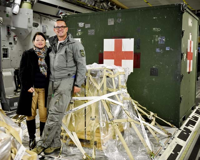Kasper Chevalier, 721st Aerial Port Squadron aerial porter, shows his wife, Frieda Chevalier, what his day-to-day job on a C-17 Globemaster III entails Oct. 16 on Ramstein. Chevalier completed his 2,000th aerial port expeditor mission during this cargo load.