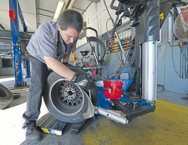 Ryan Dyle, Ramstein Auto Skills Center mobile equipment servicer, replaces a summer tire for a winter tire Oct. 1 on Ramstein. The auto center provides services to put winter tires on a vehicle or the space and equipment if one wishes to change their tires themselves.