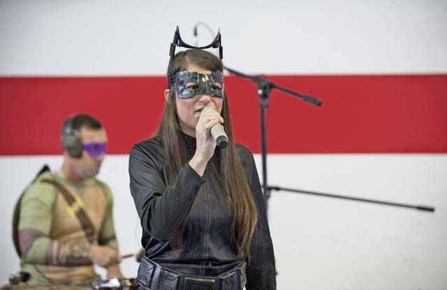 U.S. Army Staff Sgt. Ashley Sangret, a vocalist with the U.S. Army Europe Band and Chorus, sings to an audience during the Red Ribbon Run Superhero 5K event.
