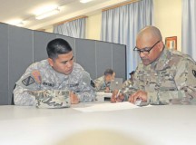 Sgt. Rodney Quintinilla and Sgt. 1st Class Ricardo Alexis of the 1st Human Resources Service Center discuss ongoing training during the unit’s Mission Readiness exercise Nov. 3.